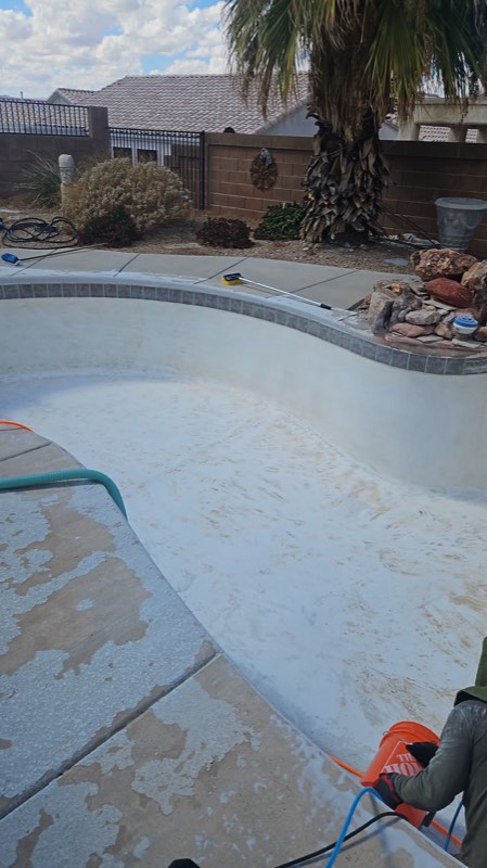 Drained fiberglass pool with the walls scraped and cleaned