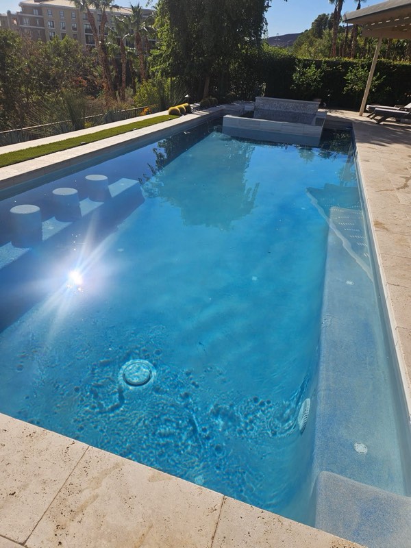 A clear, freshly serviced backyard pool in Las Vegas